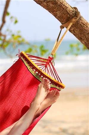 photography looking down at feet - Womans leg on hammock Stock Photo - Premium Royalty-Free, Code: 6102-07843847