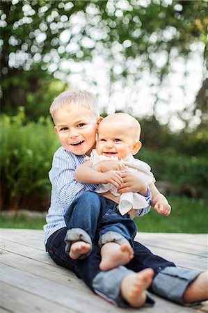 sister hugs baby - Boy hugging baby sister Stock Photo - Premium Royalty-Free, Code: 6102-07843828