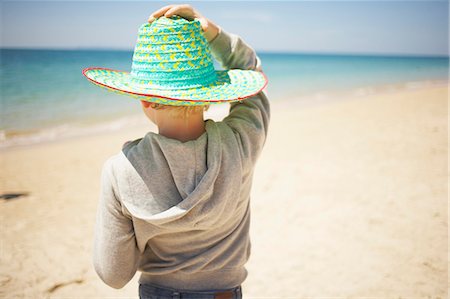 photos beach boys in asia - Boy wearing sun hat on beach Stock Photo - Premium Royalty-Free, Code: 6102-07843909