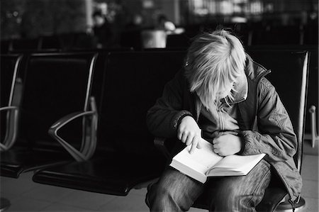 Boy reading book, low section Stock Photo - Premium Royalty-Free, Code: 6102-07843920