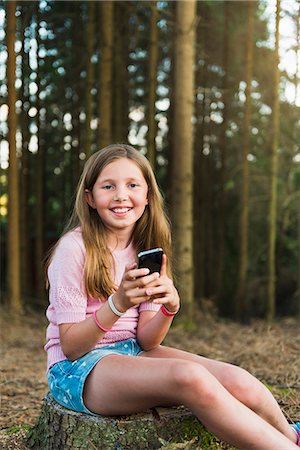 portrait digital technology - Girl with cell phone at forest Stock Photo - Premium Royalty-Free, Code: 6102-07844081