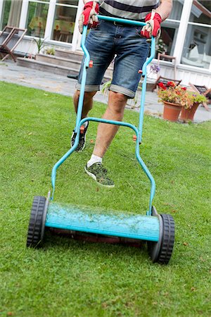 elevated view of lawnmower - Man mowing lawn, low section Stock Photo - Premium Royalty-Free, Code: 6102-07844014