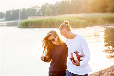 romantic beach sunset - Young couple with football Stock Photo - Premium Royalty-Free, Code: 6102-07844032
