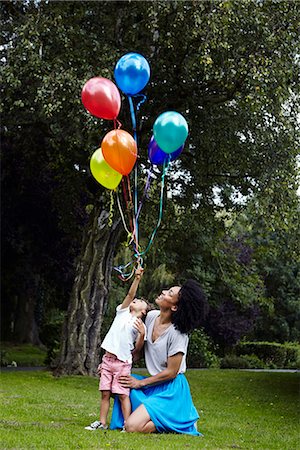 Mother with son holding bunch of balloons Stock Photo - Premium Royalty-Free, Code: 6102-07844132