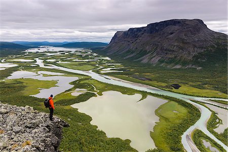 standing alone cliff - Hiker looking at view from cliff Stock Photo - Premium Royalty-Free, Code: 6102-07844325