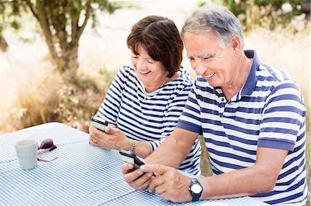 picture of woman with old mobile phone - Mature couple with cell phones Stock Photo - Premium Royalty-Free, Code: 6102-08063011