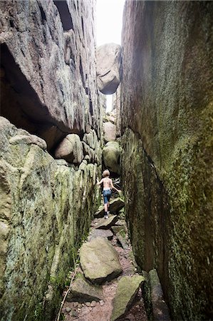 shirtless, boy - Boy walking in crevice Stock Photo - Premium Royalty-Free, Code: 6102-08000515