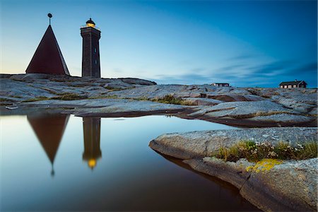 simsearch:6102-08270982,k - Lighthouse reflecting on water Stock Photo - Premium Royalty-Free, Code: 6102-08000609