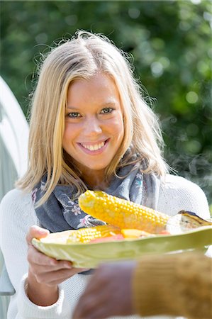simsearch:6102-08521005,k - Smiling woman with corn on cob Foto de stock - Royalty Free Premium, Número: 6102-08000722
