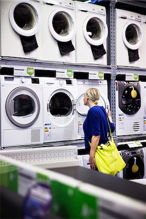 simsearch:6102-06336700,k - Woman looking at washing machines in shop Foto de stock - Sin royalties Premium, Código: 6102-08000832