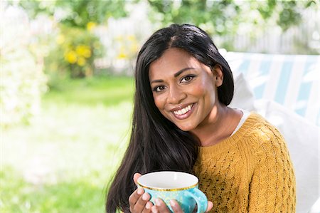 simsearch:6102-07769055,k - Young woman with cup in garden Stock Photo - Premium Royalty-Free, Code: 6102-08000838