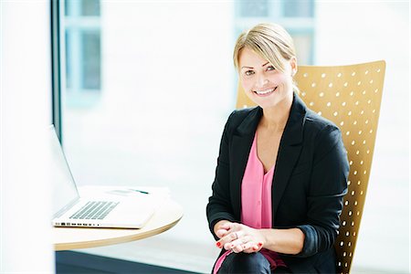 professional on laptop - Young businesswoman sitting in office Stock Photo - Premium Royalty-Free, Code: 6102-08001239
