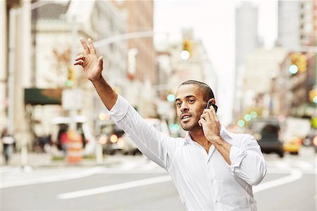 Man on the phone hailing taxi Stock Photo - Premium Royalty-Free, Code: 6102-08001324