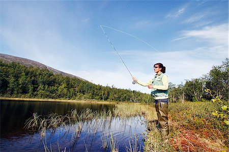 Woman fly fishing Stock Photos, Royalty Free Woman fly fishing