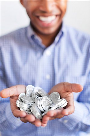 simsearch:6102-08168957,k - Man holding silver coins Stock Photo - Premium Royalty-Free, Code: 6102-08168952