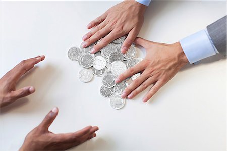 simsearch:6102-08168957,k - Businessmen hands holding coins Stock Photo - Premium Royalty-Free, Code: 6102-08168958