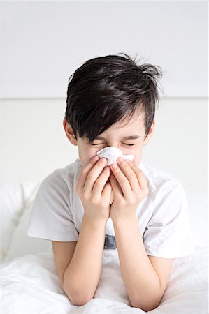 Boy blowing his nose Stock Photo - Premium Royalty-Free, Code: 6102-08168913