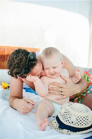 simsearch:6102-08120367,k - Father with baby playing on outdoor bed Stock Photo - Premium Royalty-Free, Code: 6102-08120353