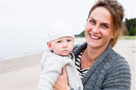 europe beach people photo - Smiling mother with baby boy Stock Photo - Premium Royalty-Free, Code: 6102-08120473