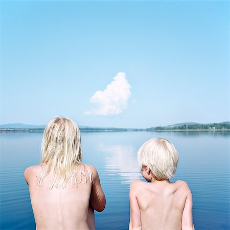 sitting girl - Boy and girl looking at water Stock Photo - Premium Royalty-Free, Code: 6102-08120531