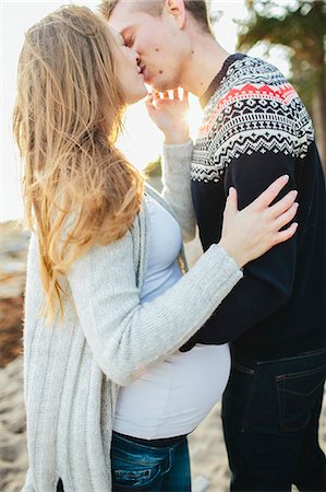 pregnant couple holiday - Young couple kissing on beach Stock Photo - Premium Royalty-Free, Code: 6102-08120663