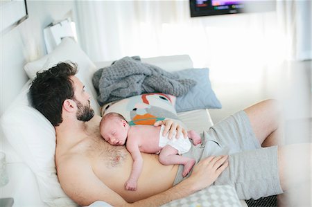 family sleeping while watching tv - Mid adult man with newborn baby Stock Photo - Premium Royalty-Free, Code: 6102-08120635