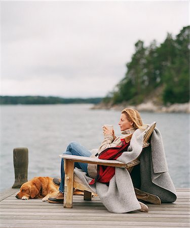 placid lake - Woman looking at water with hot drink Stock Photo - Premium Royalty-Free, Code: 6102-08120882