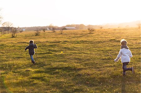 stick people running - Boys running through meadow Stock Photo - Premium Royalty-Free, Code: 6102-08270726