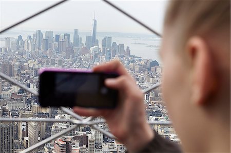 Young woman taking photo of Manhattan with her smartphone, New York City, USA Stock Photo - Premium Royalty-Free, Code: 6102-08270987