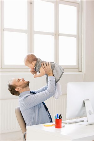 simsearch:6102-07602586,k - Father with baby girl in office Stock Photo - Premium Royalty-Free, Code: 6102-08271022