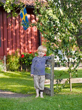 Boy standing in garden Stock Photo - Premium Royalty-Free, Code: 6102-08271030
