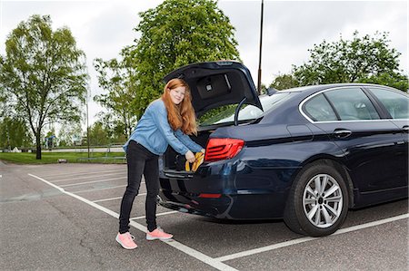 Woman putting backpack in car boot Stock Photo - Premium Royalty-Free, Code: 6102-08271511