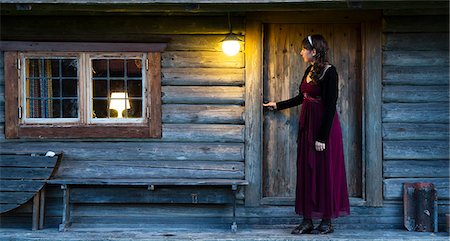 simsearch:6102-08271069,k - Woman in front of wooden house Stock Photo - Premium Royalty-Free, Code: 6102-08271690