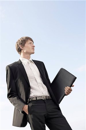 simsearch:6102-08566469,k - Young businessman against blue sky Stock Photo - Premium Royalty-Free, Code: 6102-08271698