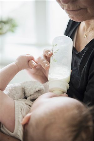 Grandmother bottle feeding baby Stock Photo - Premium Royalty-Free, Code: 6102-08271791