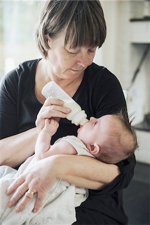 Grandmother bottle feeding baby Stock Photo - Premium Royalty-Free, Code: 6102-08271792