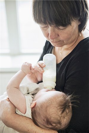 Grandmother bottle feeding baby Stock Photo - Premium Royalty-Free, Code: 6102-08271794