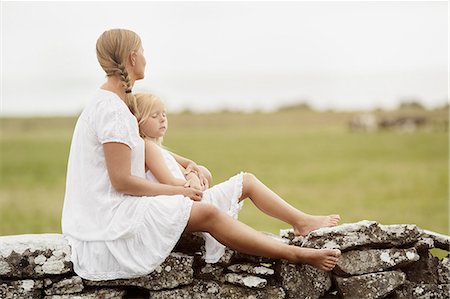 simsearch:6102-08329857,k - Mother with daughter sitting on stone wall Stock Photo - Premium Royalty-Free, Code: 6102-08271815