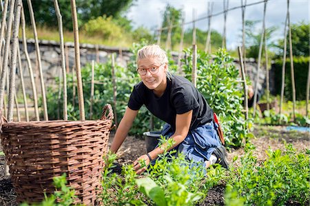 Young woman working in garden Stock Photo - Premium Royalty-Free, Code: 6102-08384147