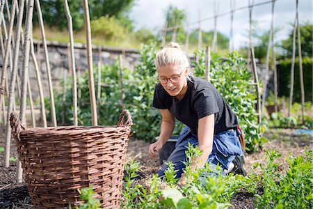 Young woman working in garden Stock Photo - Premium Royalty-Free, Code: 6102-08384146