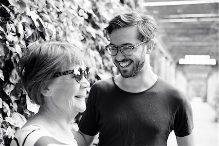 son and mother walking in black and white - Smiling woman with adult son Stock Photo - Premium Royalty-Free, Code: 6102-08384167