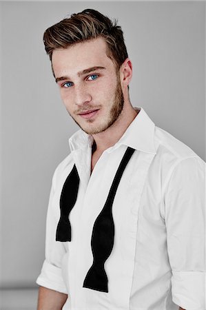 party young adult elegant - Portrait of man wearing shirt and bow tie Stock Photo - Premium Royalty-Free, Code: 6102-08384348