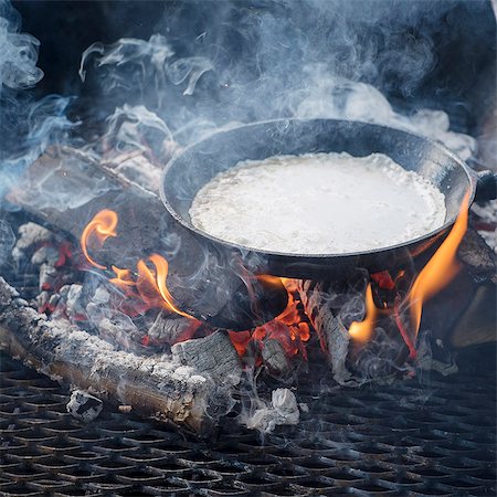 pot cooking over a fire - Pan with food on fire Stock Photo - Premium Royalty-Free, Code: 6102-08384360