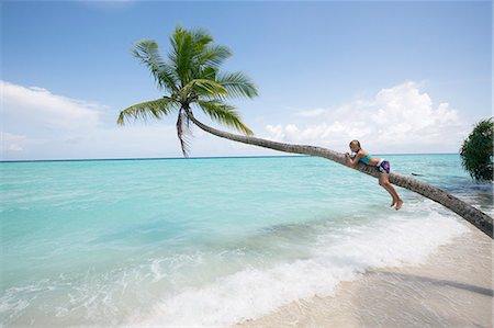 single coconut tree picture - Girl on tropical beach Stock Photo - Premium Royalty-Free, Code: 6102-08384381