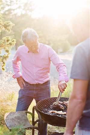 seniors barbecuing - Men having barbecue Stock Photo - Premium Royalty-Free, Code: 6102-08384395