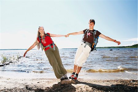 Smiling female friends at water Fotografie stock - Premium Royalty-Free, Codice: 6102-08388052