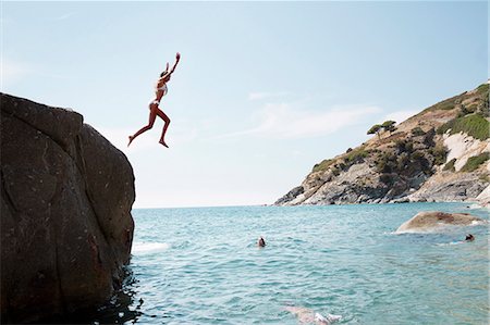 Woman jumping into sea Stock Photo - Premium Royalty-Free, Code: 6102-08388164