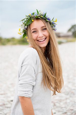 Smiling teenage girl wearing flower wreath Stock Photo - Premium Royalty-Free, Code: 6102-08388178