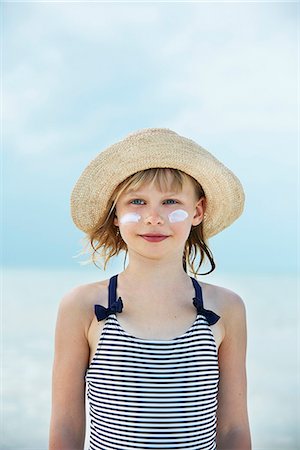 simsearch:6102-08388289,k - Portrait of girl with face cream by sea Stock Photo - Premium Royalty-Free, Code: 6102-08388294