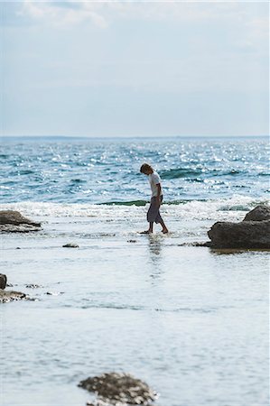 Boy walking on beach Stock Photo - Premium Royalty-Free, Code: 6102-08388408